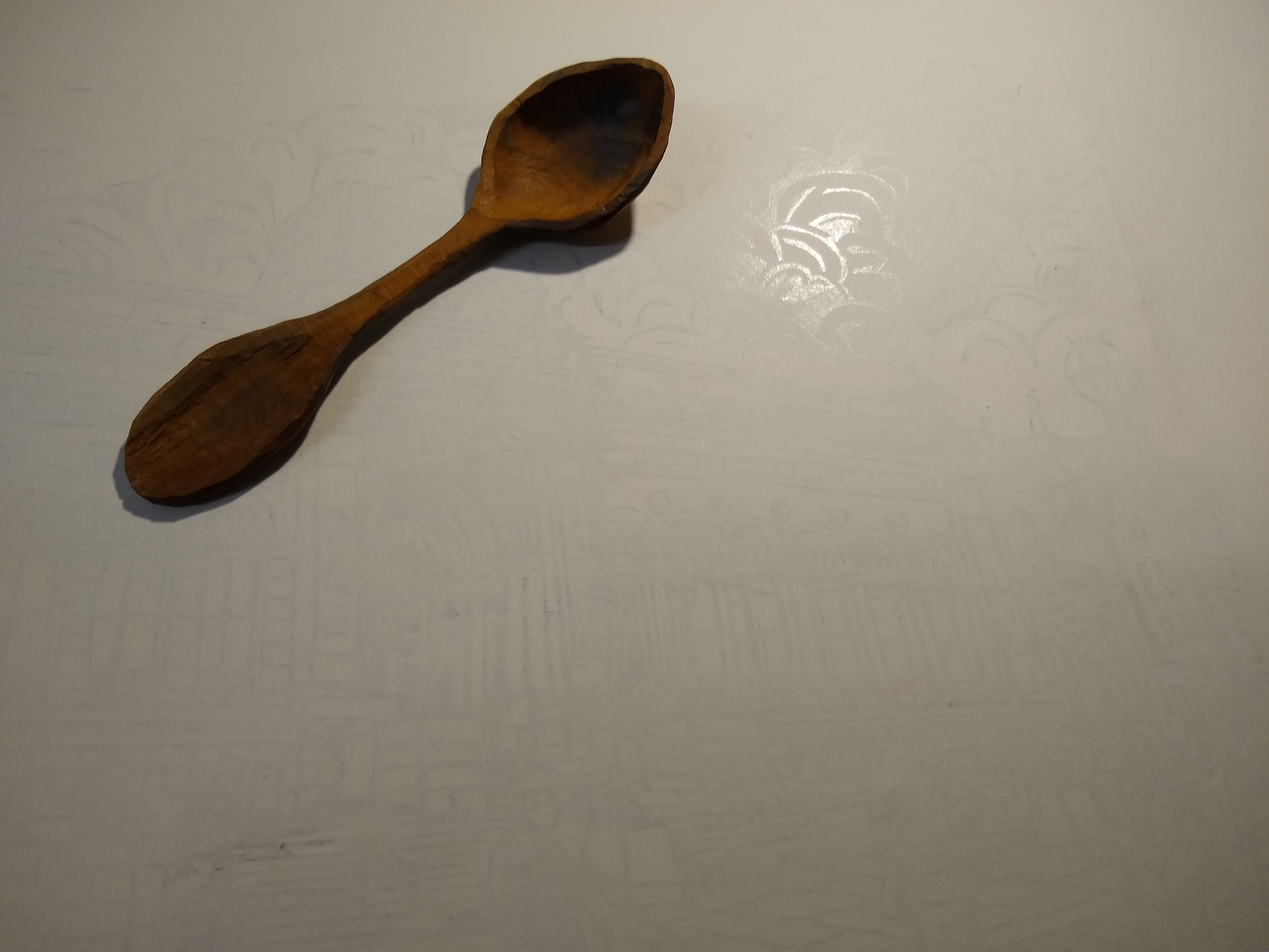 Hand burnishing with a wooden spoon